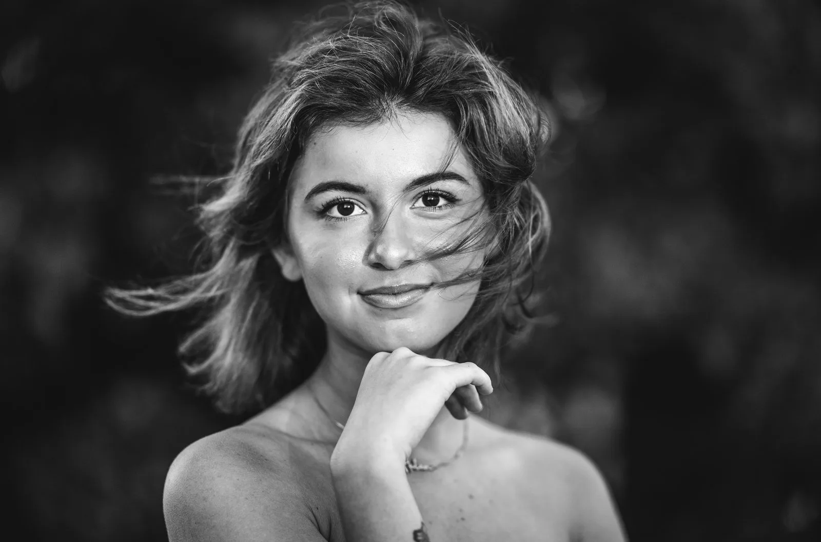 Black and white senior portrait with windswept hair